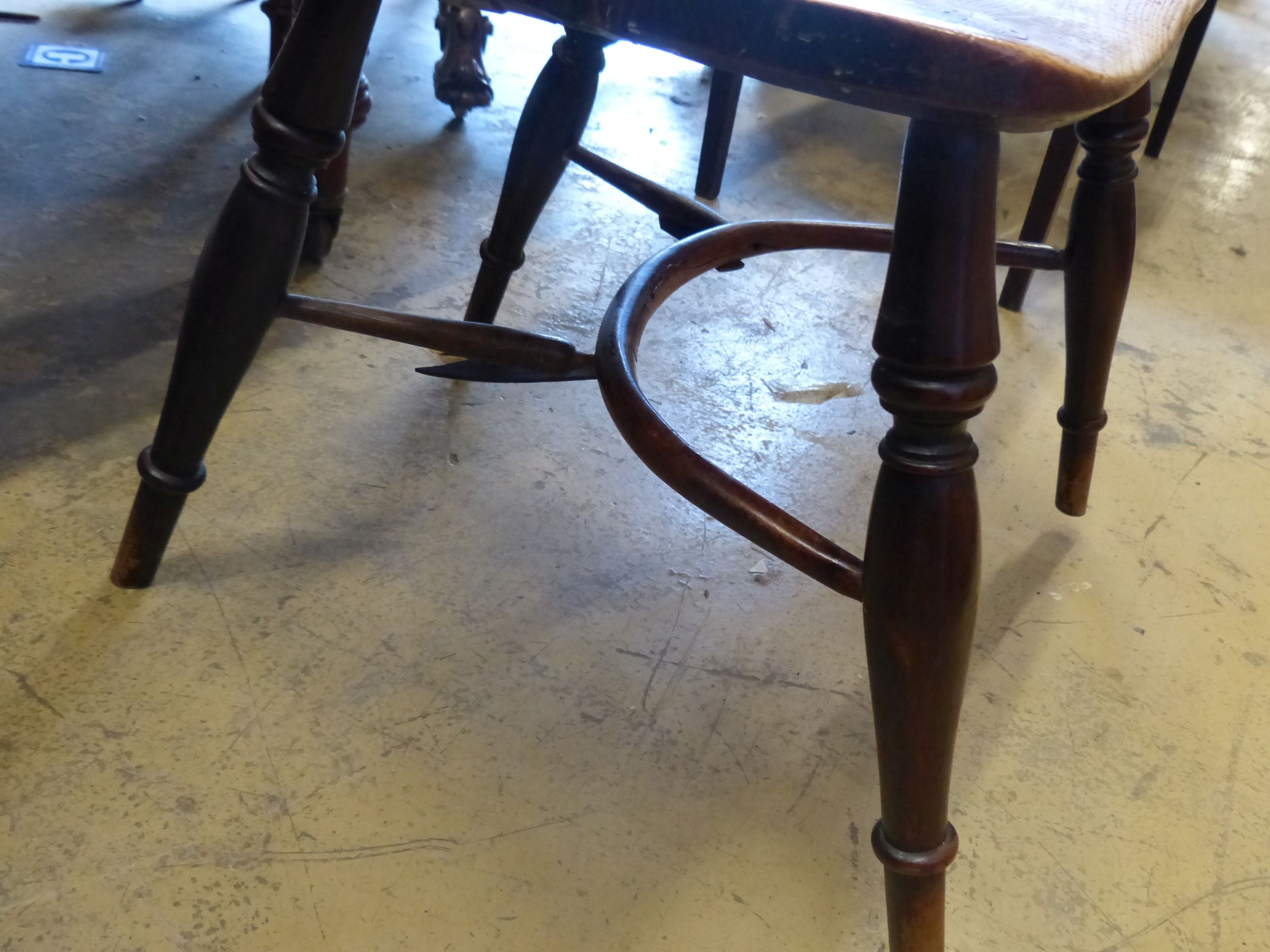 An early 19th century yew and elm Windsor kitchen elbow chair